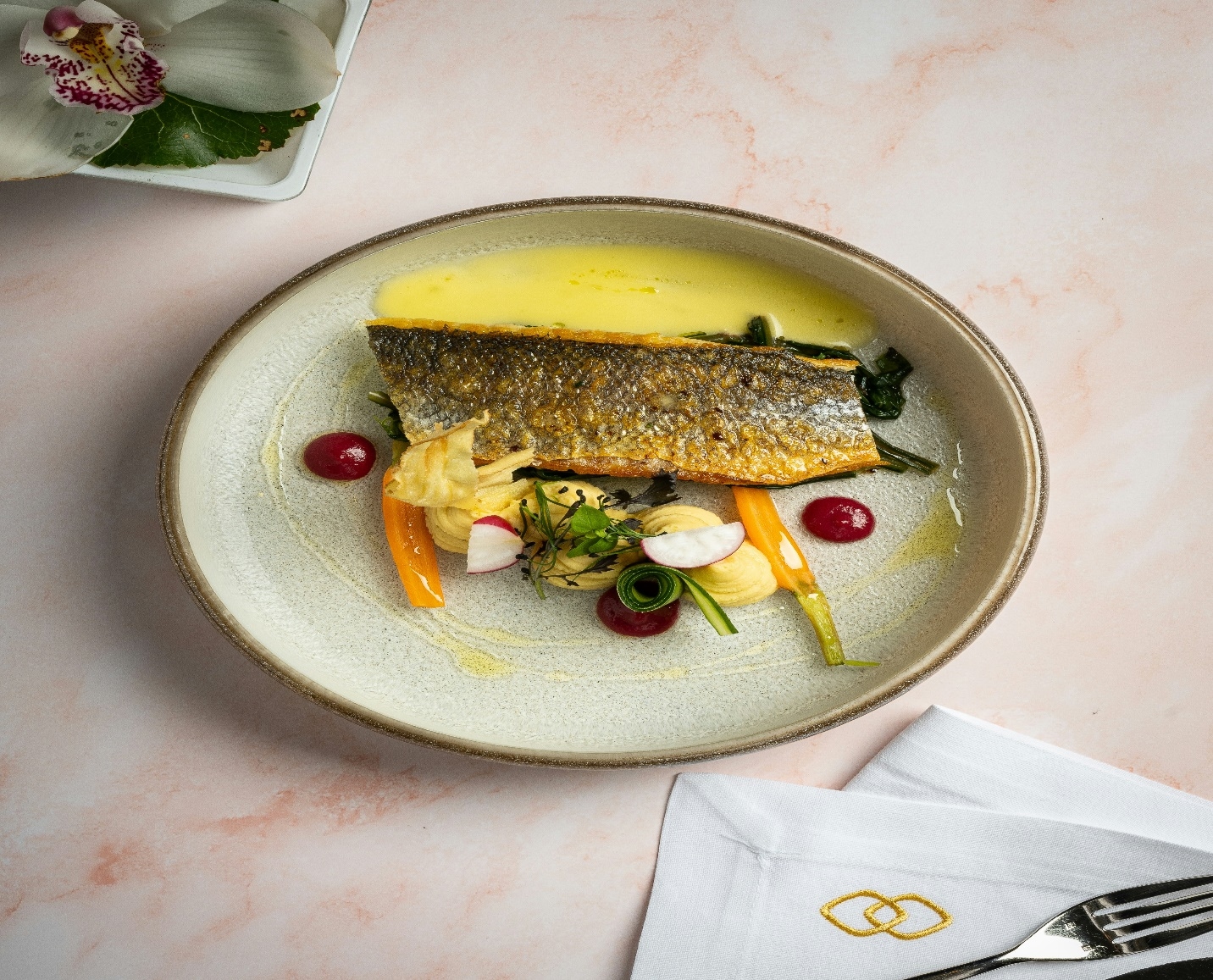 Plated trout fillet with citrus butter sauce